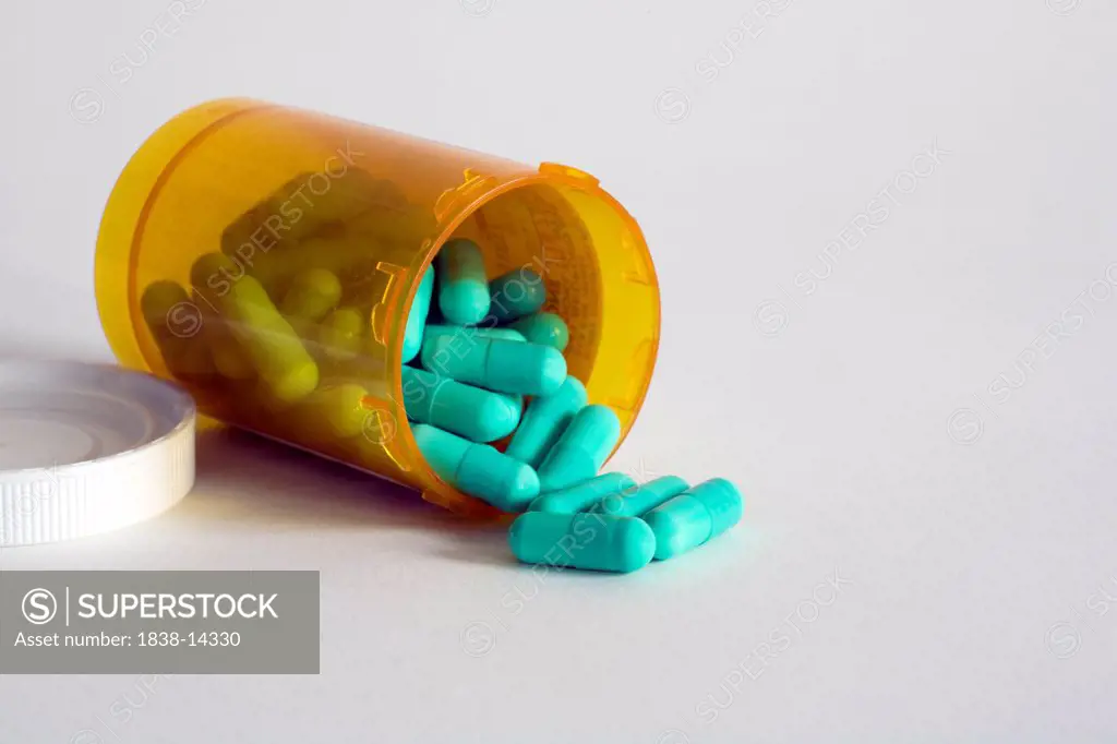 Capsules Spilling from Pill Bottle, Close Up