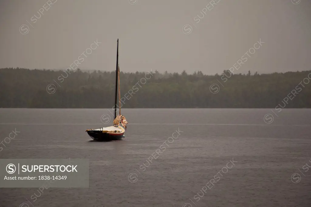 Sailboat Moored in Lake During Rain