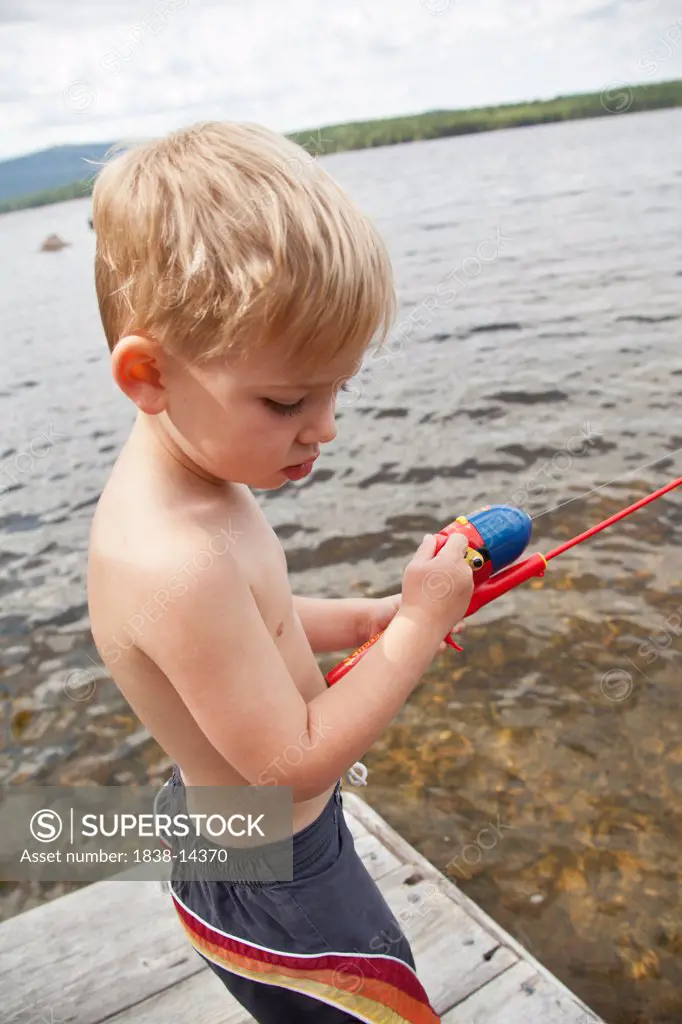 Young Boy Fishing on Dock
