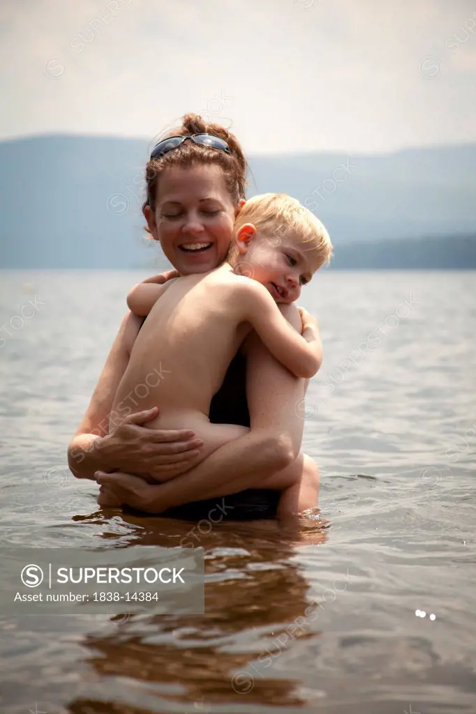 Mother Holding Son in Lake