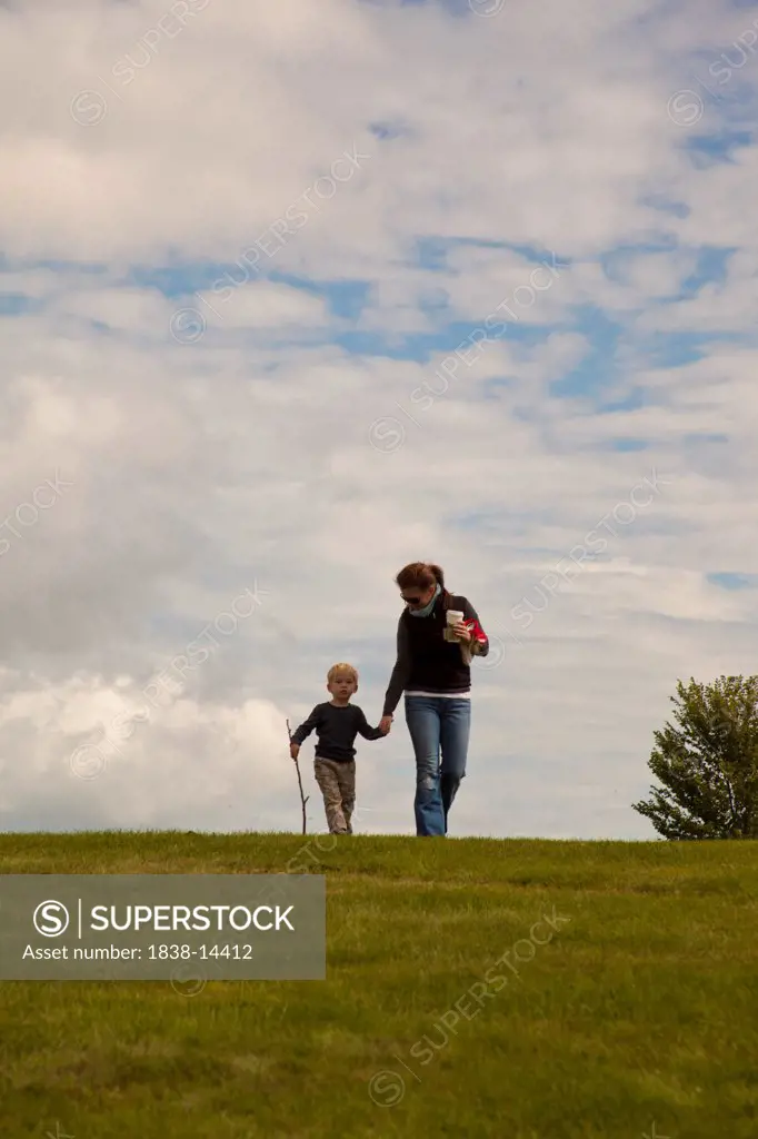 Mother and Son Walking Over Hill