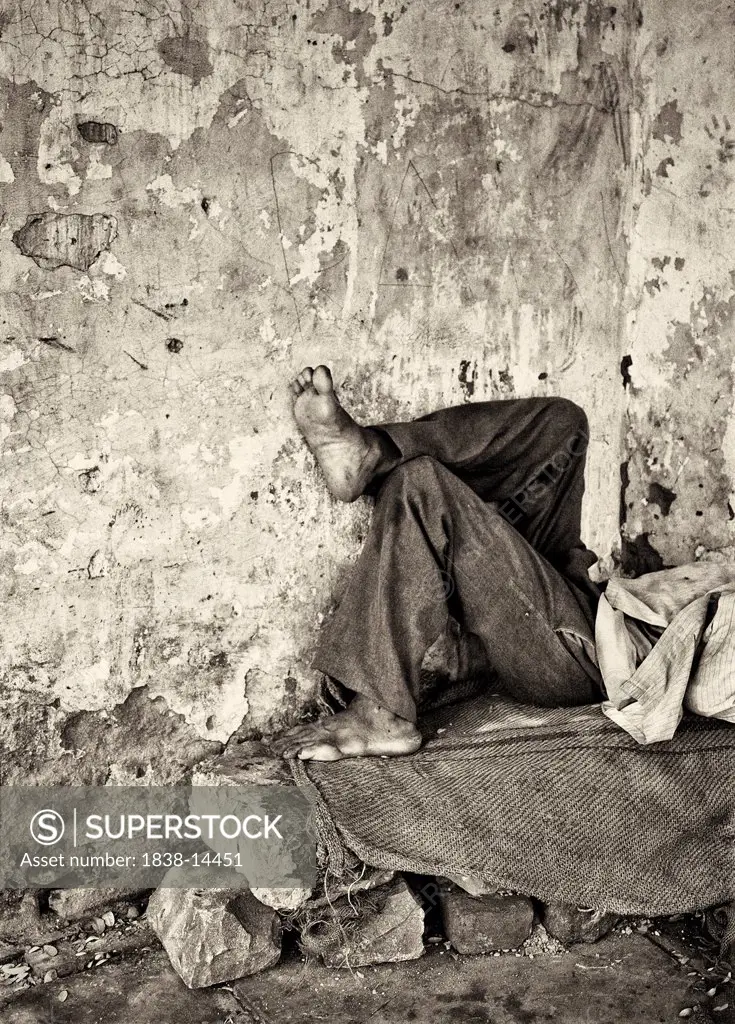 Man Laying on Stone Bench, New Delhi, India