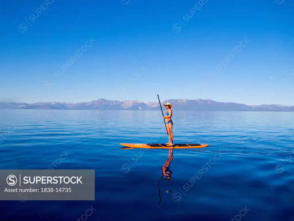 Woman Standing on Paddleboard Holding Paddle 2
