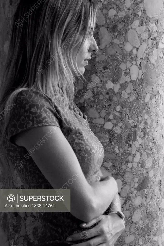 Contemplative Woman Against Wall, Waist-Up, Profile