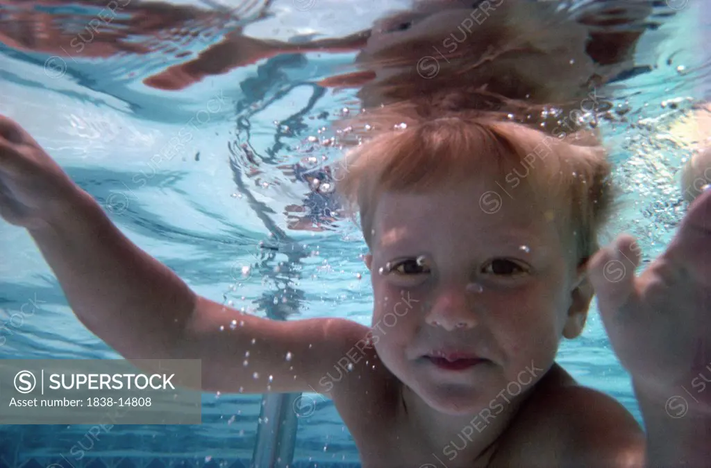Young Boy Swimming Underwater, Eye Contact