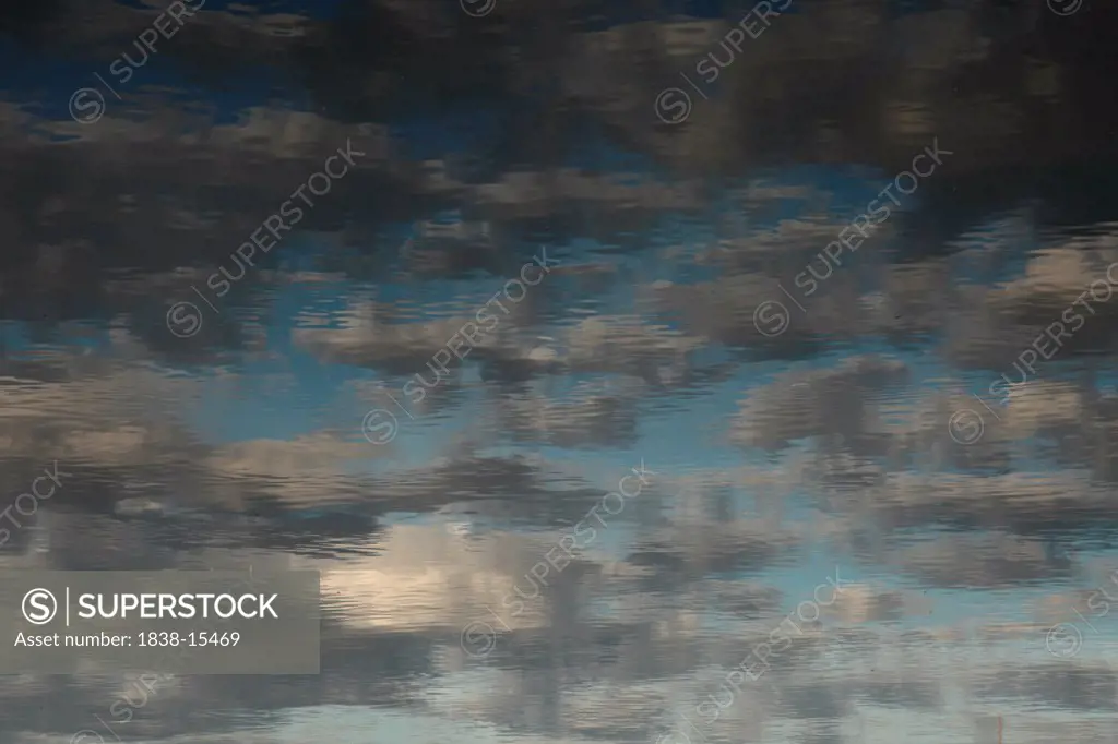 Reflection of Blue Sky and Clouds on Water