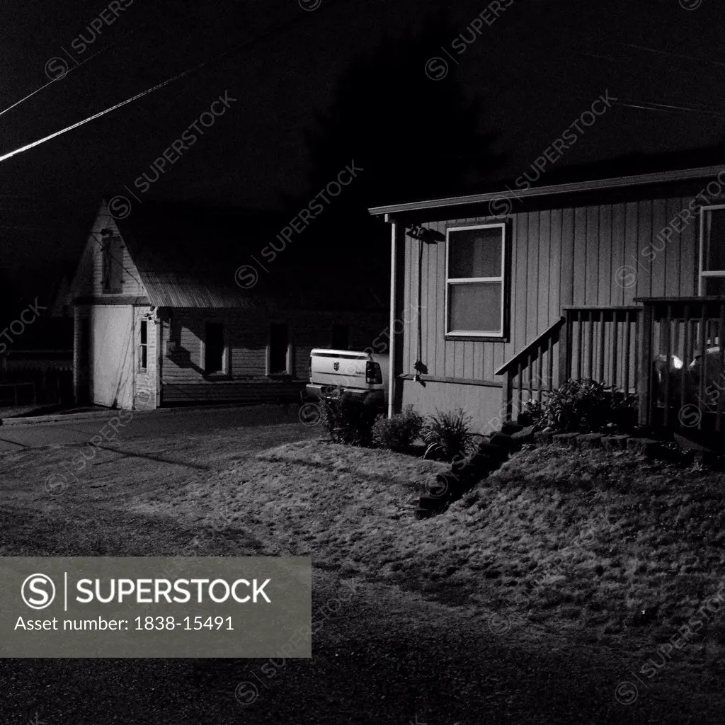 Small Suburban House and Detached Garage at Night