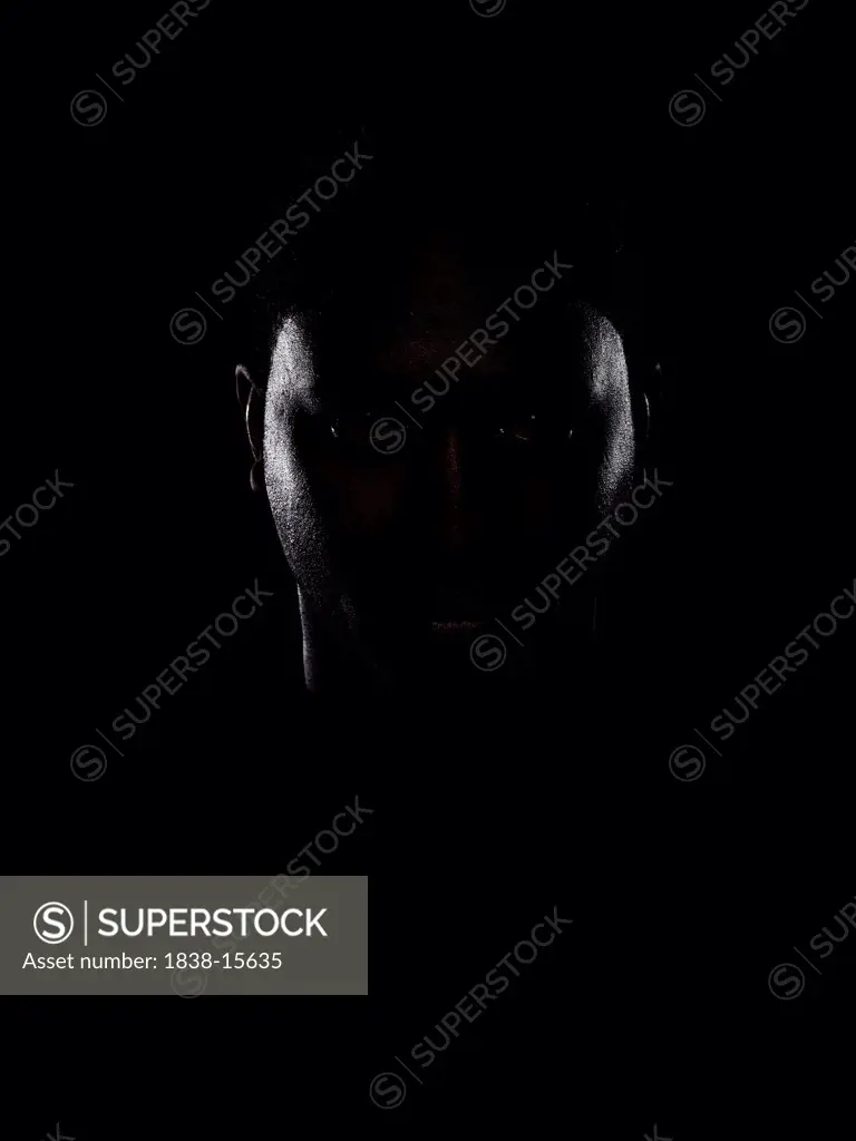 Serious Young Man in Dark Shadow, Portrait