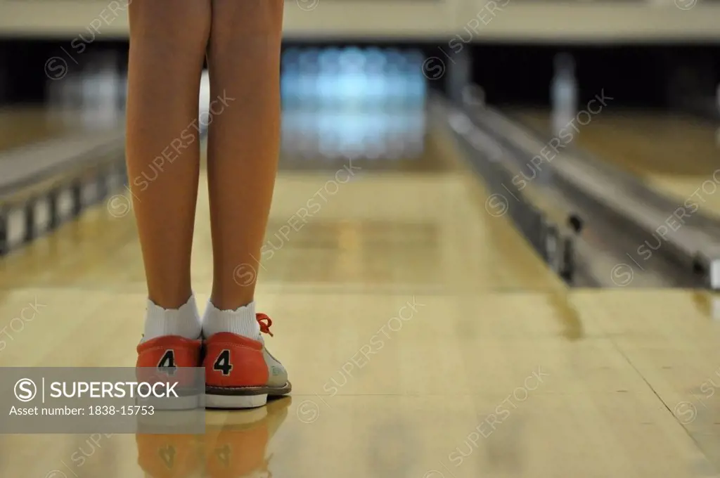 Young Girl Bowling, View of Legs and Feet, Rear View