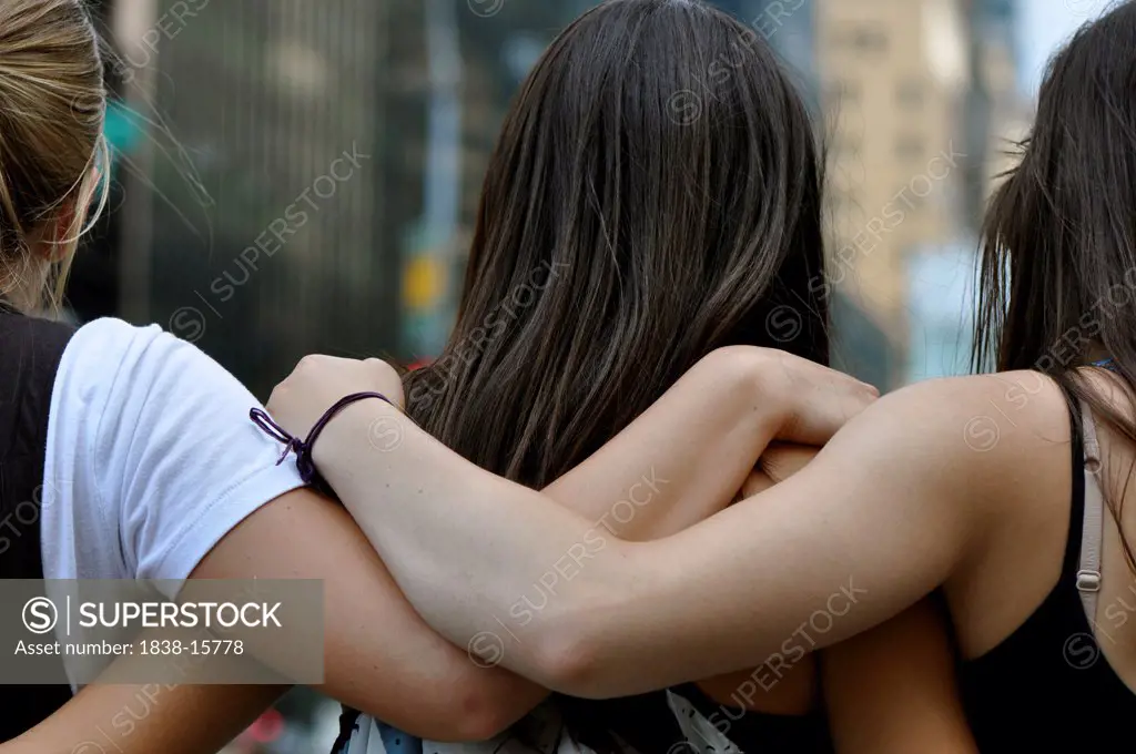 Three Young Women with Arms Around Each Other, Close Up, Rear View