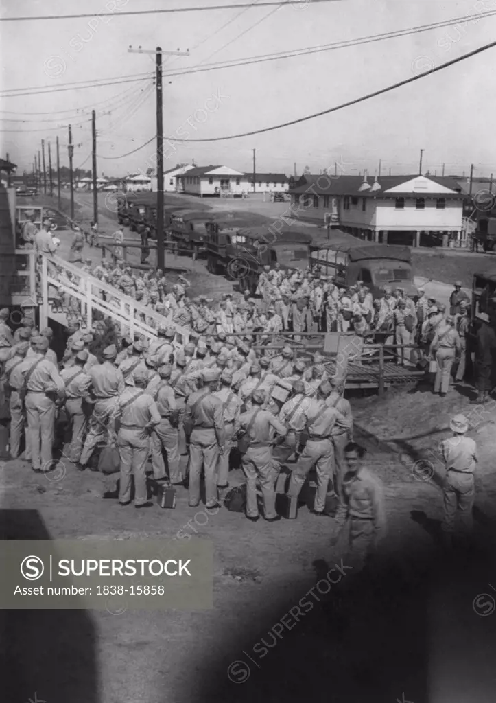 Group of Soldiers Boarding Trucks, Awaiting Departure for East Coast USA with Eventual Departure by Ship to Europe, WWII, HQ 2nd Battalion, 389th Infantry, US Army Military Base, Indiana, USA,  1942