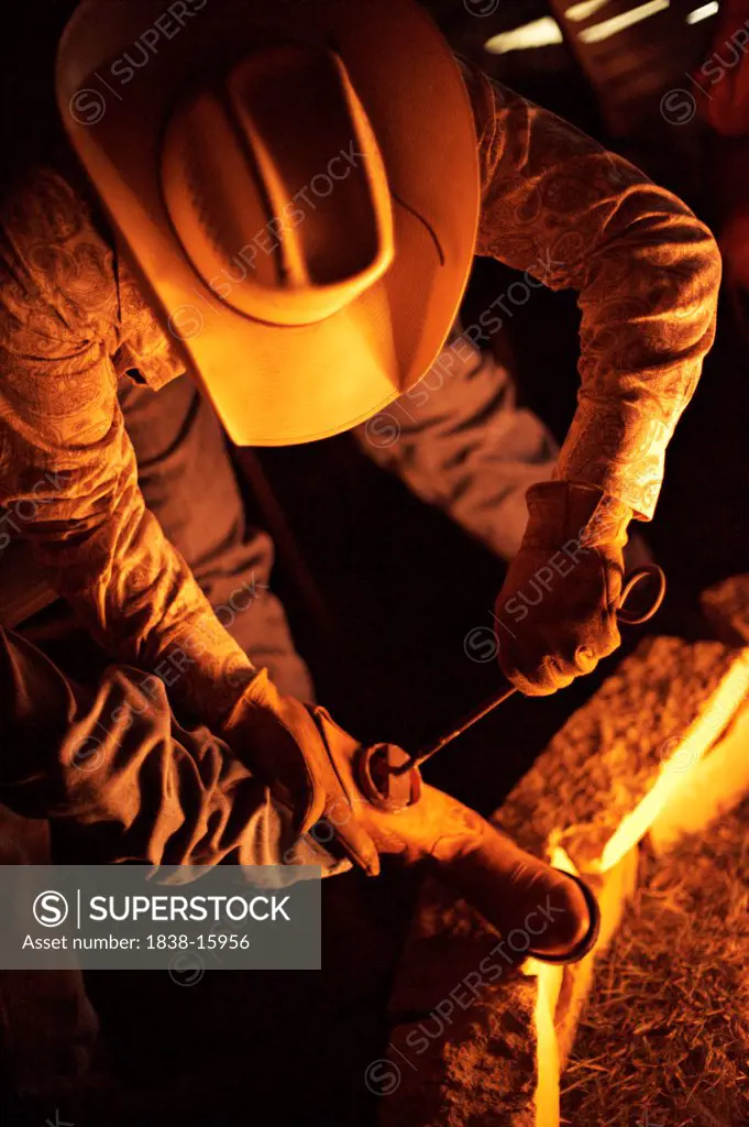 Cowboy Boots Being Branded with Branding Iron