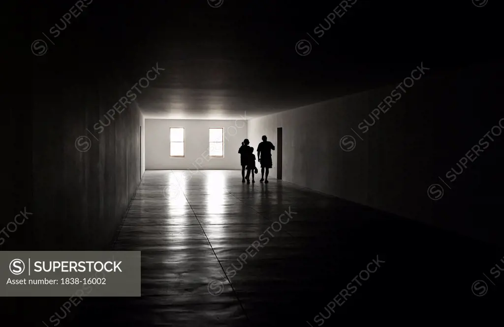 Shadowy Figures in Dark Corridor