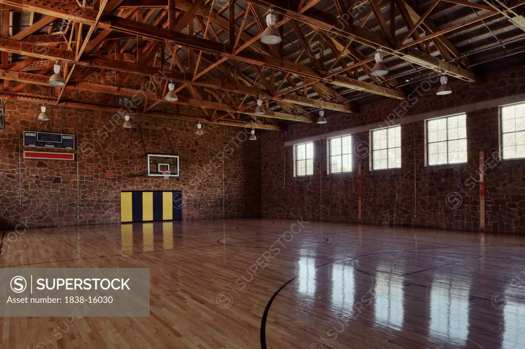 Basketball Gymnasium with Stone Walls and Row of Windows