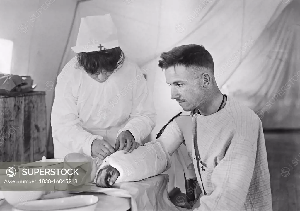 American Red Cross Nurse bandaging arm of Wounded American Soldier, American Military Hospital No. 5, a complete portable Tent Hospital supported by American Red Cross, Auteuil, France, Lewis Wickes Hine, American National Red Cross Photograph Collection, June 1918