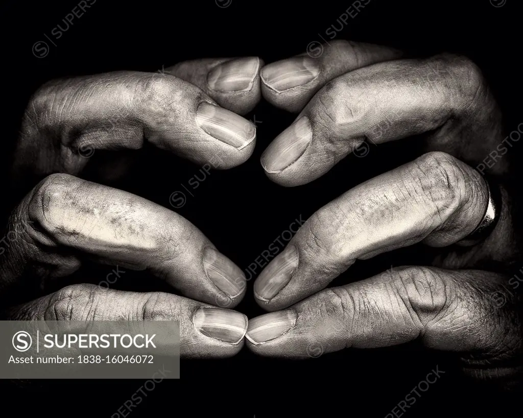 Close-Up of Touching Fingertips against Black Background