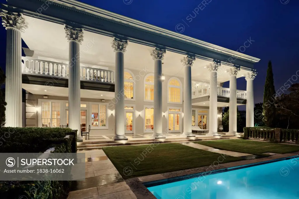 Mansion with Columns and Swimming Pool at Night