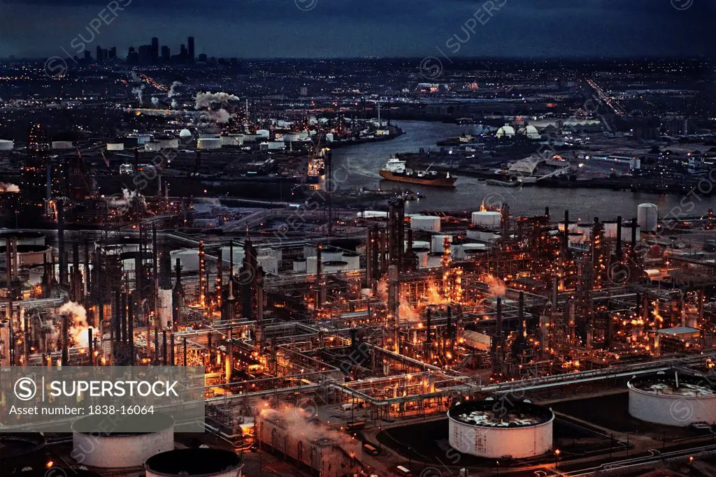 Oil Refinery with Skyline in the Background at Night, Houston, Texas, USA