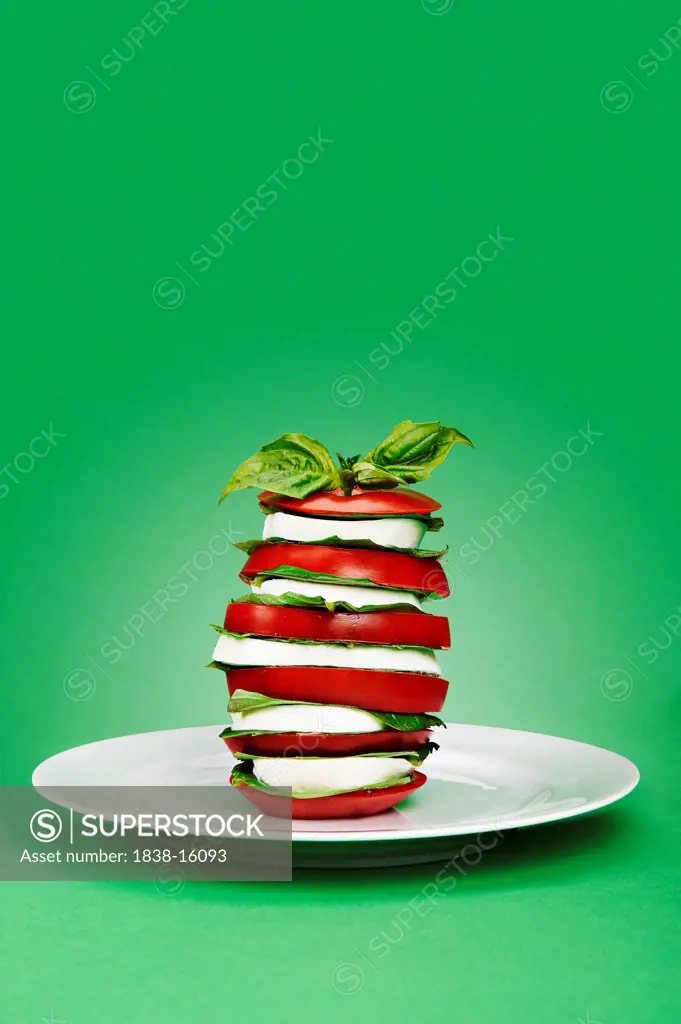 Tomato Caprese Salad Stack on Green Background