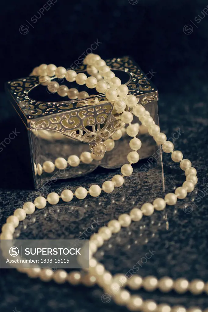 Strand of Pearls on Top of Silver Box