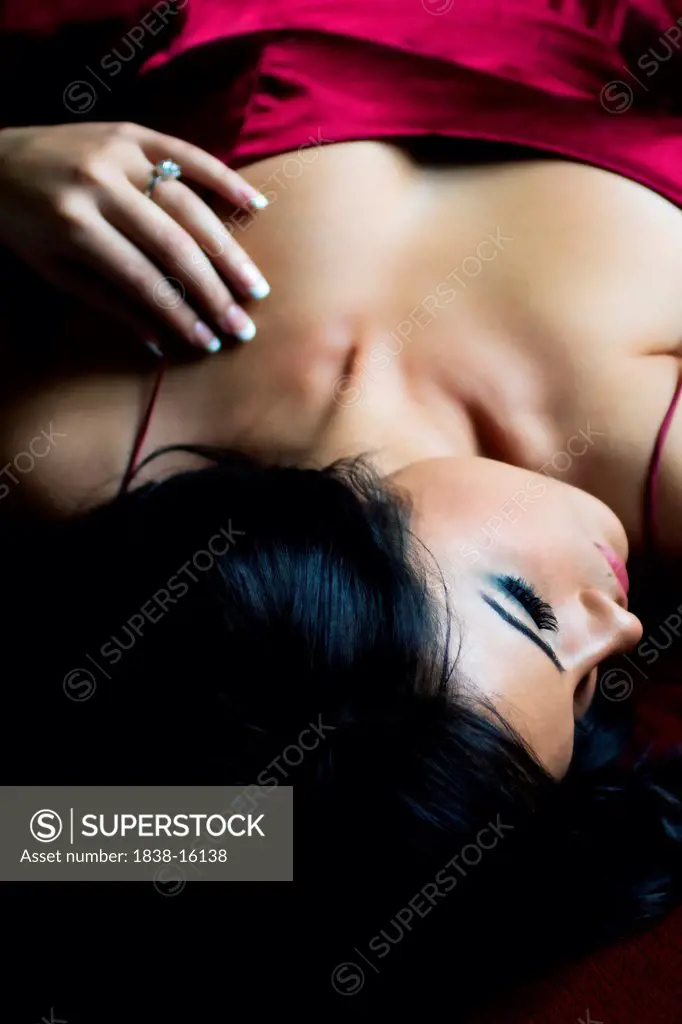 Attractive Young Woman Wearing Silk Lingerie in Sensuous Pose