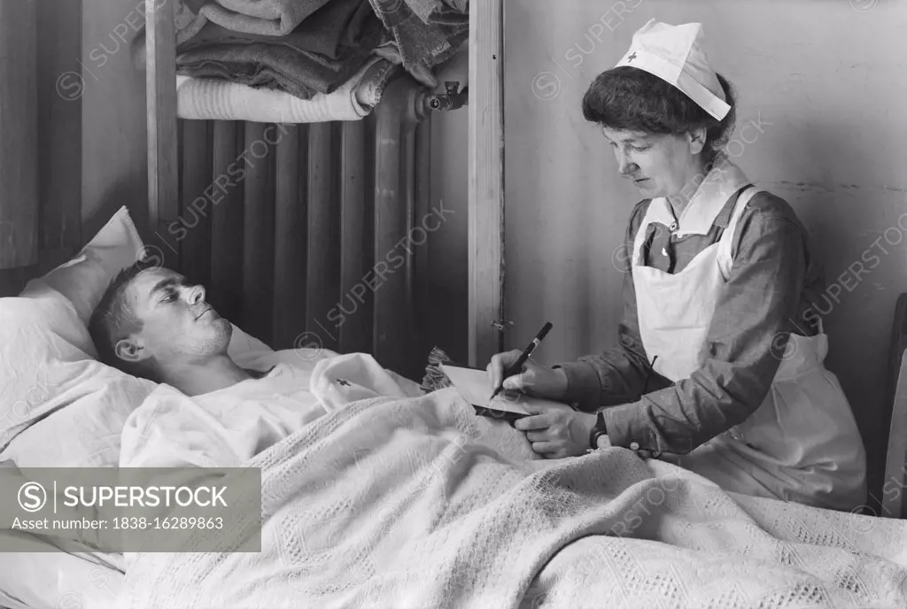 Nurse writing a Letter Home for a wounded American Soldier at the American Military Hospital No. 1, Neuilly, France, Lewis Wickes Hine, American National Red Cross Photograph Collection, June 1918
