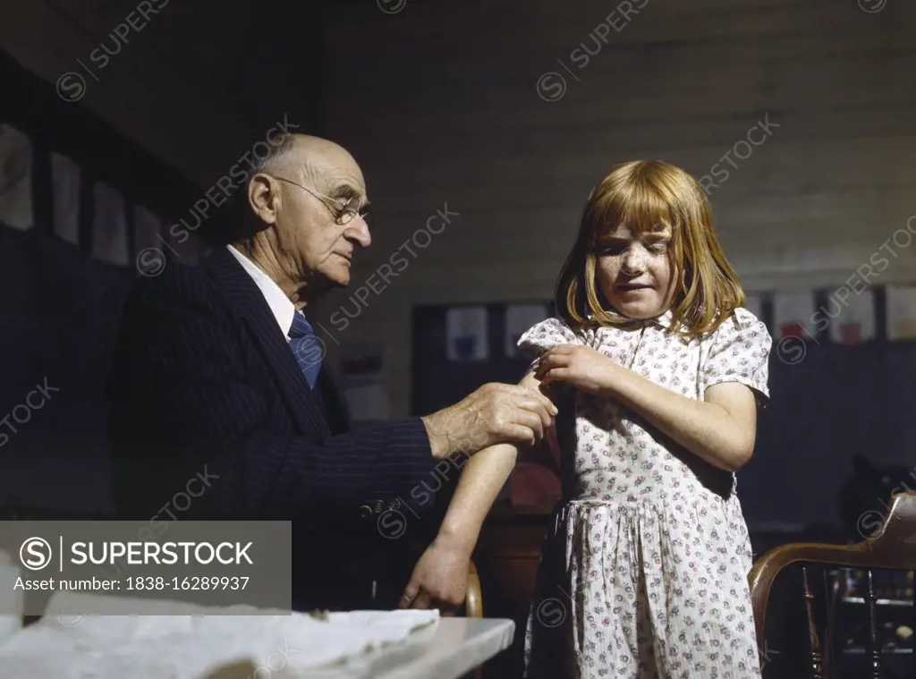 Dr. Schreiber of San Augustine giving a typhoid inoculation at a rural school, San Augustine County, Texas, USA, John Vachon, U.S. Farm Security Administration, April 1943