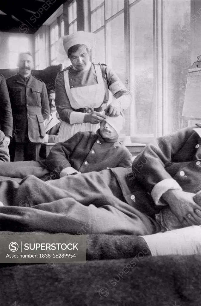 Nurse bandaging Head of Soldier at Canadian Base Hospital during World War I, Hotel du Golf, Le Touquet, France, Bain News Service, 1914