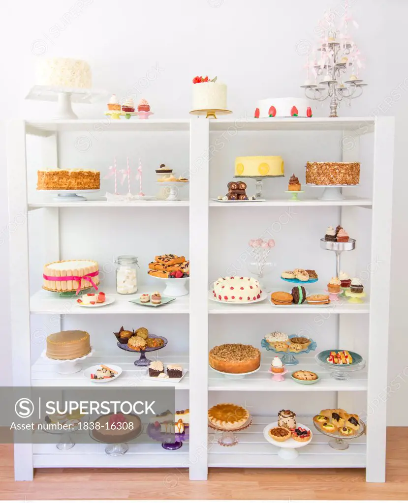 Assorted Desserts on White Shelves
