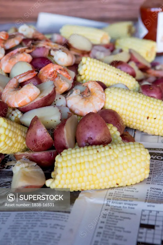 Low Country Boil with Shrimp, Corn, Sausage and Potatoes on Newspaper, Close Up