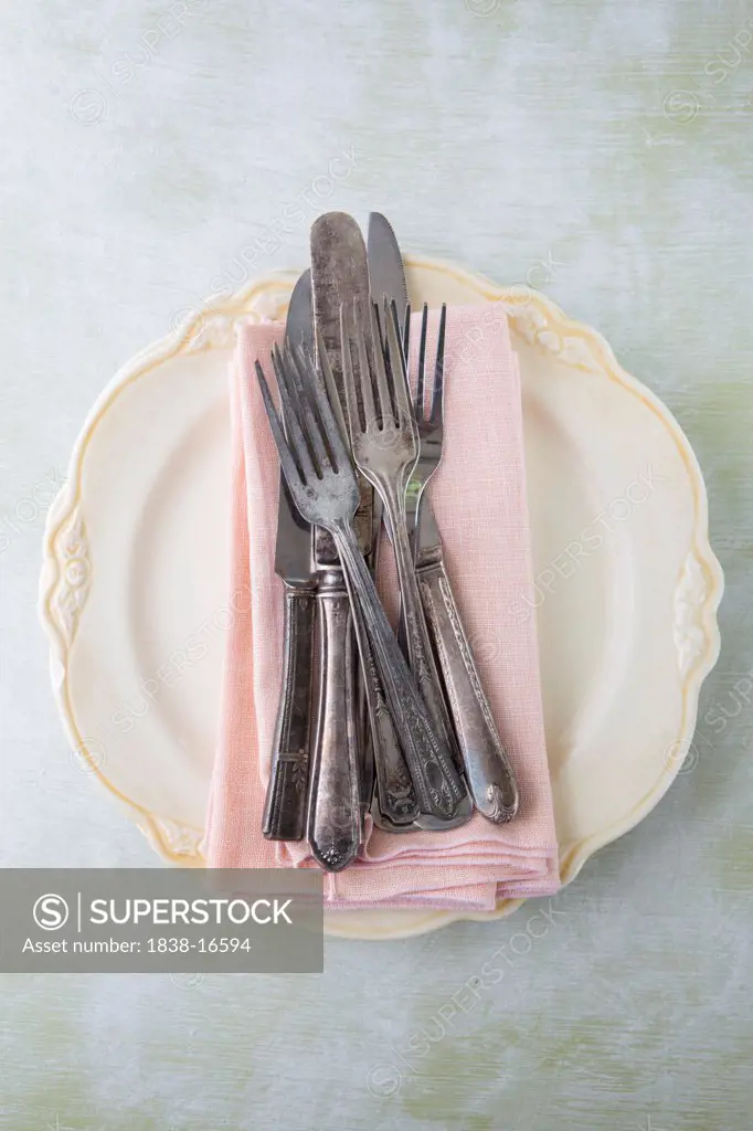 Pink Napkins and Silverware on Plate, High Angle View