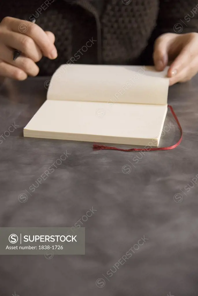 Woman's Hands and Blank Journal 