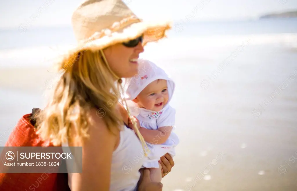 Mother and Baby on Sunny Beach 