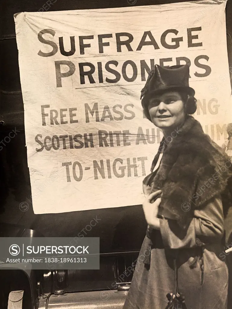 Lucy Branham, American Suffragist, standing in front of banner, "Suffrage Prisoners", National Woman's Party, March 1919