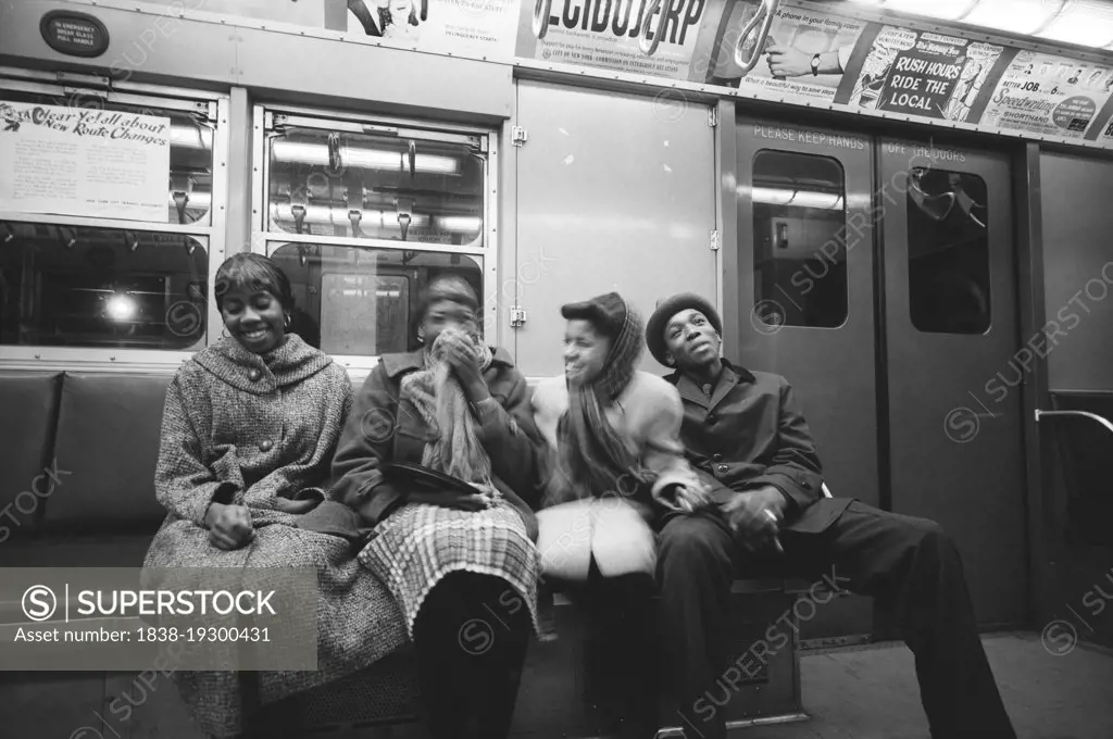 Four young adults sharing Laugh on Subway, New York City, New York, USA, Angelo Rizzuto, Anthony Angel Collection, February 1959