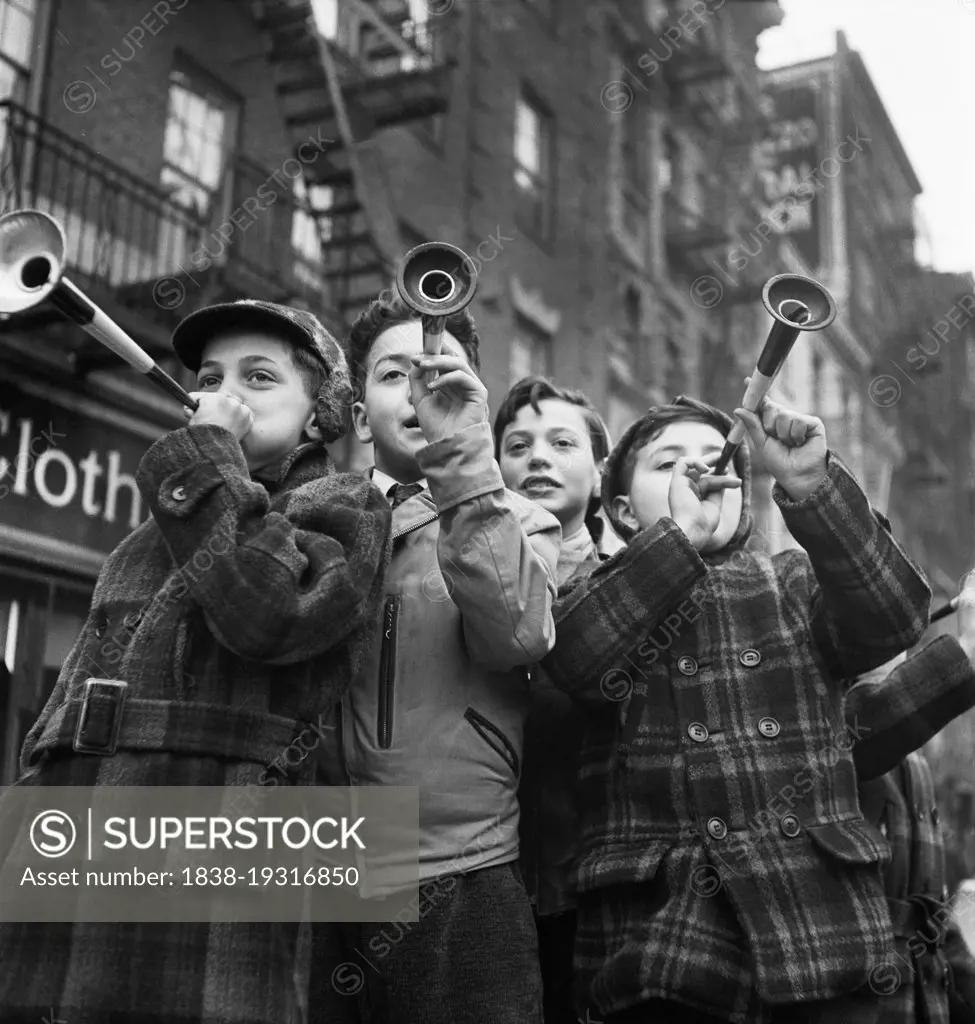 Four Boys blowing horns on New Year's Day, Bleecker Street, New York City, New York, USA, Marjory Collins, U.S. Office of War Information/U.S. Farm Security Administration, January 1943
