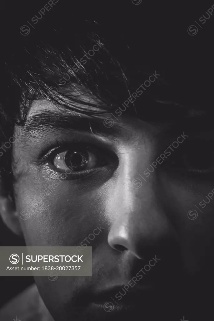 Moody Portrait of Young Man with Focus on Eye