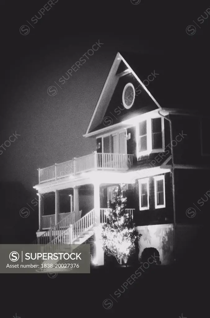 Illuminated House in Fog at Night
