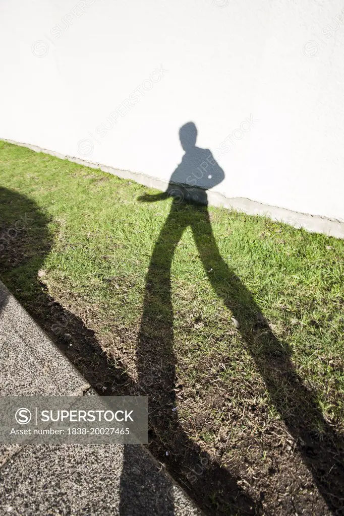 Female Shadow on Grass and Building