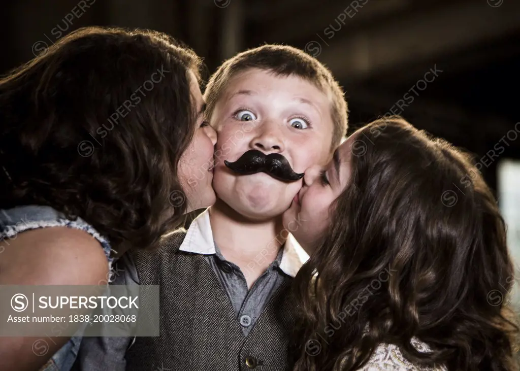 Two Girls Kissing Boy with Wax Lips in Abandoned Warehouse