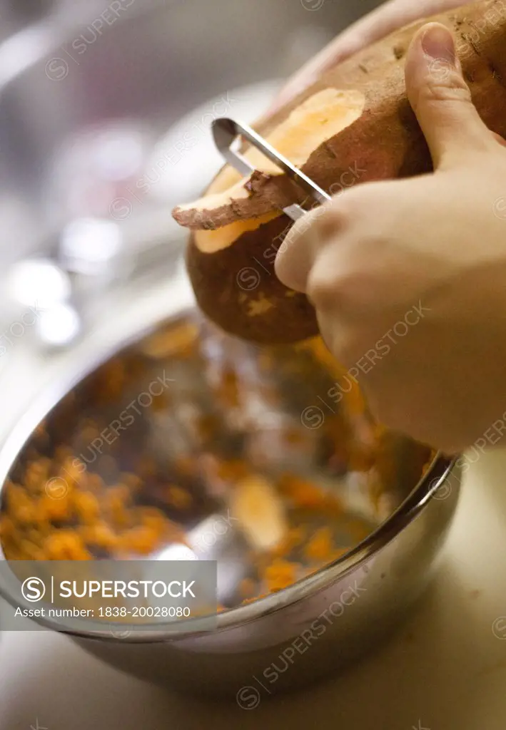 Woman Peeling Sweet Potato