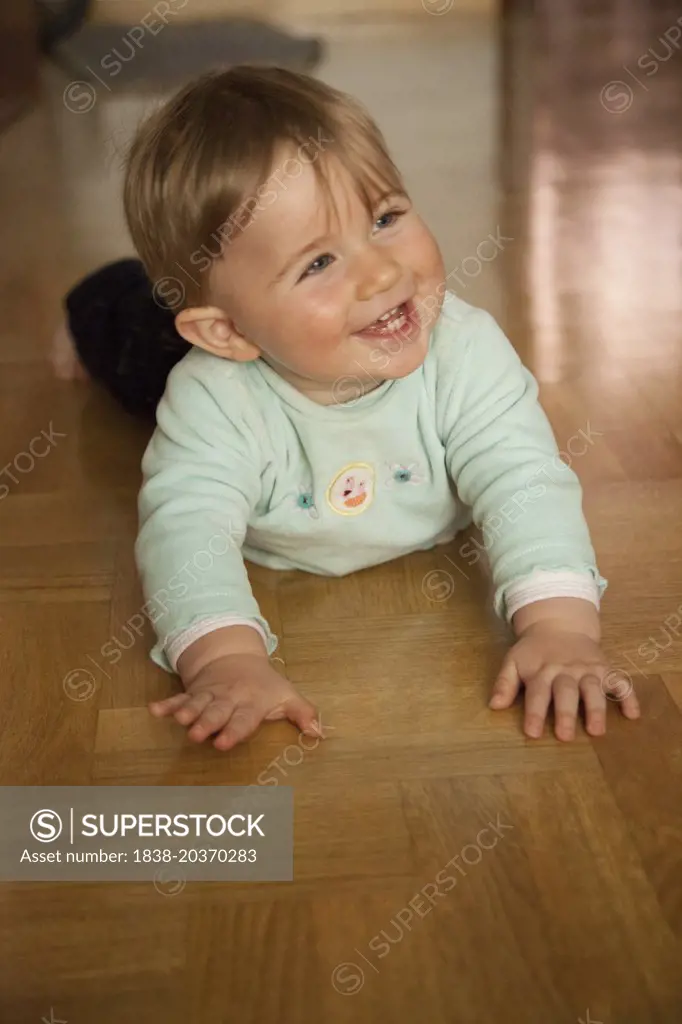 Smiling Baby Crawling on Floor