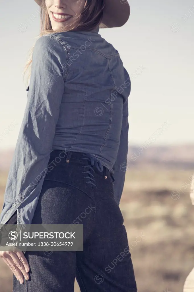 Rear View Portrait of Woman Wearing Vintage Denim Shirt and Lace-Up Jeans  