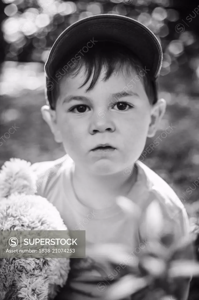 Portrait of Young Boy Holding Stuffed Animal