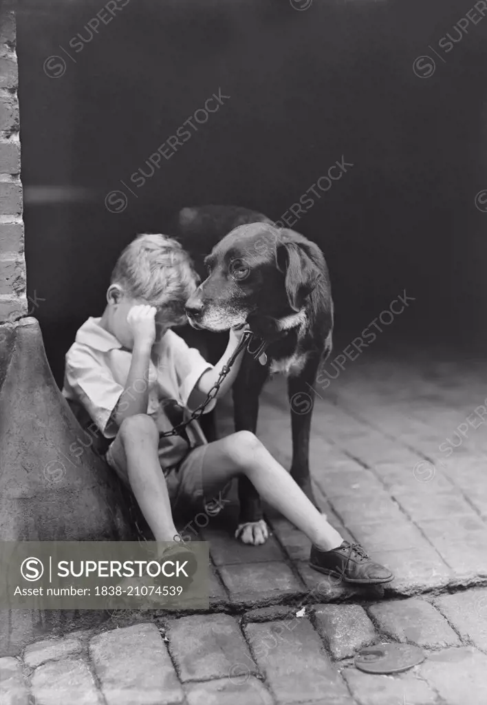 Sad Boy with Dog, USA, circa 1921