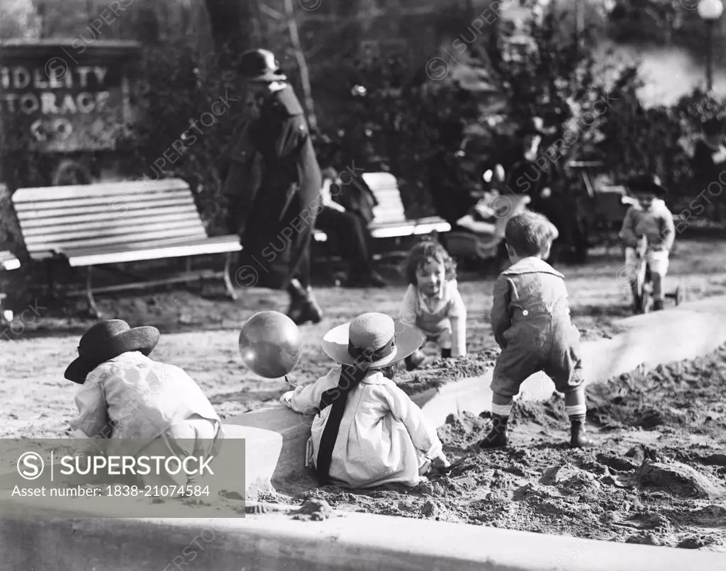 Group of Children Playing in Playground Sandbox, USA, circa 1920