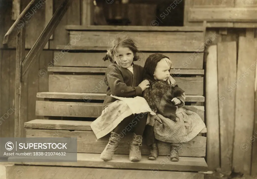 Portrait of Young Girl Taking Care of Baby Sister While Rest of Family is Working at Local Cannery, Bayou La Batre, Alabama, USA, circa 1911