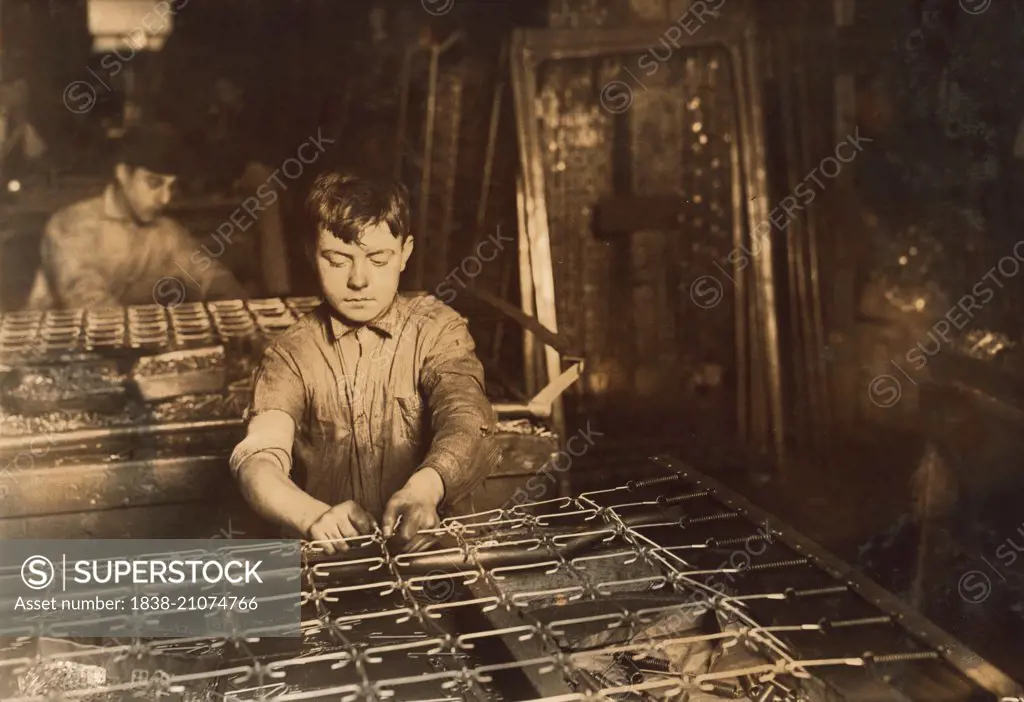 Young Boy Linking Bed Springs, Boston, Massachusetts, USA, circa 1917