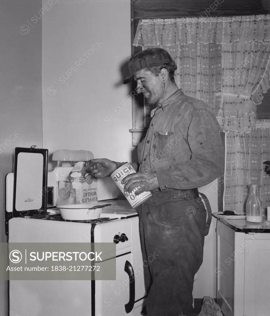 Coal Miner Making Breakfast at Home after Returning from Night Shift Work, Westover, West Virginia, USA, Marion Post Wolcott for Farm Security Administration, September 1938