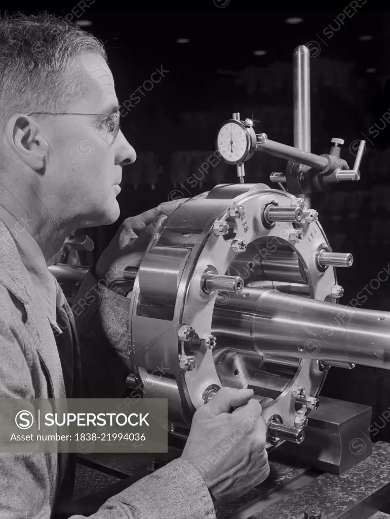 Worker Carefully Checking an Airplane Propeller Shaft for Concentricity at Manufacturing Plant, Pratt & Whitney, East Hartford, Connecticut, USA, Andreas Feininger for Office of War Information, June 1942